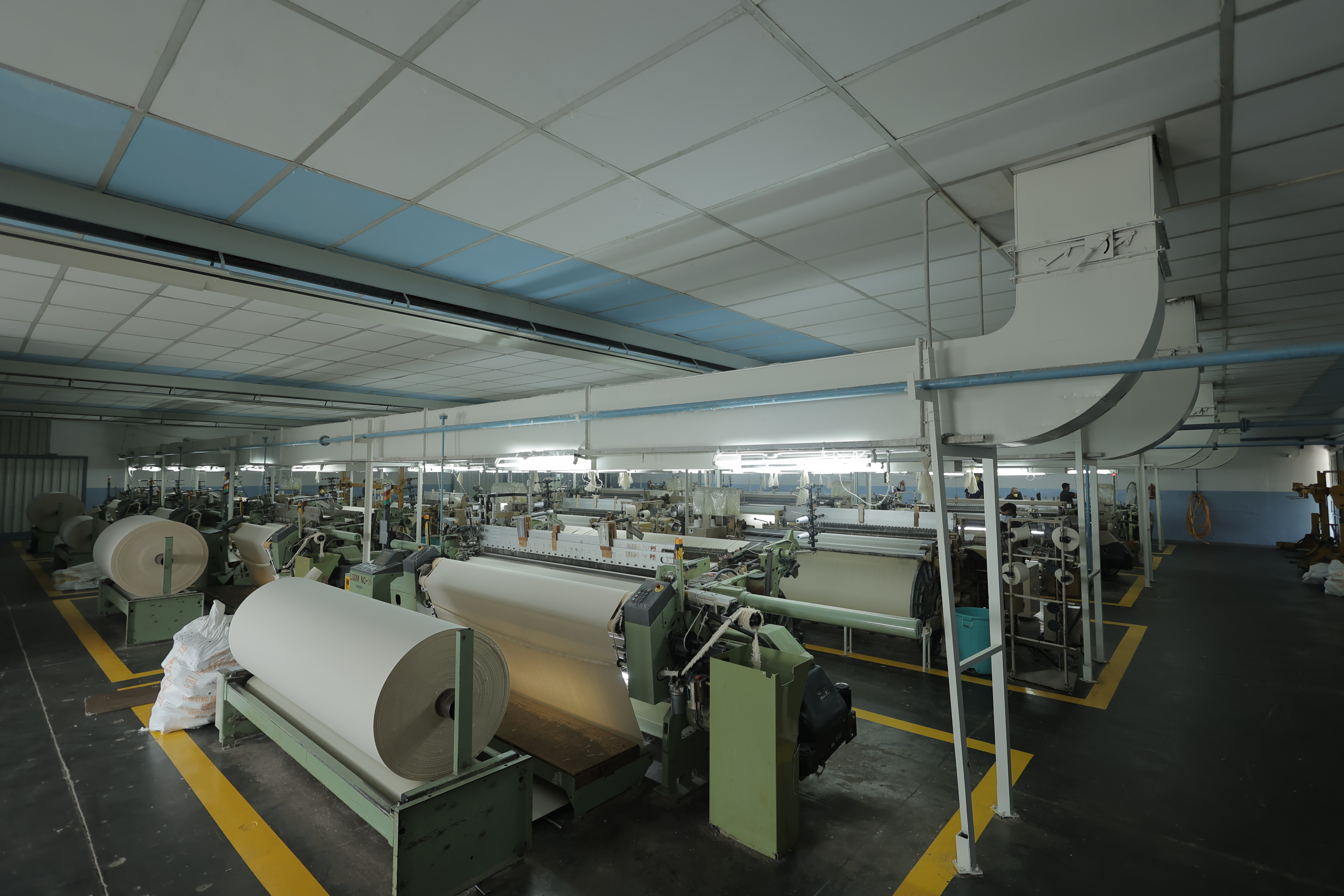 Weaving looms in operation on Umed's weaving floor